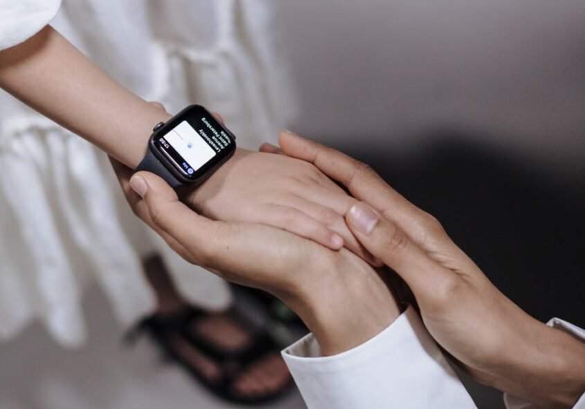 Parent holding the hand of their child wearing fitness tracker | Fitness for kids India